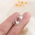 Elegant S925 silver rabbit pearl earrings with crystal accents shown in hand - Silver