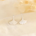 Detailed view of silver ginkgo leaf earrings with fine texture on linen background - Ginkgo Leaf Hook