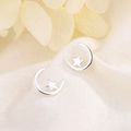 Minimalist S925 sterling silver moon and star stud earrings on elegant textured fabric - Silver