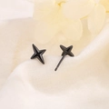 Minimalist black four-pointed star stud earrings on white textured fabric background - Black (214 Black)