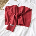 Red knitted shawl faux collar with decorative woven label on a clean white background - 42x95cm / Red
