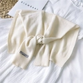 Beige knitted shawl collar with rib-knit edges and black label on white texture - 42x95cm / Cream