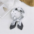White silk-style scarf featuring black stars and moon patterns with elegant knot detail - Starry Night White