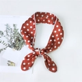 Rust red polka dot skinny silk scarf with white contrast piping tied in a bow - Orange