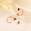 Minimalist rose gold clover screw earrings on textured fabric background - Rose Gold