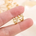 Golden bow huggie earrings with baguette zircon stones held for size reference - Gold (HL-75金色)