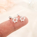 Star-shaped silver screw back earrings featuring a hollow hexagram design on a fingertip - Silver (C156)