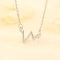 Elegant silver heartbeat necklace for women with a minimalist ECG pendant on beige fabric - Heartbeat Style (W28)