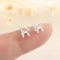 Polished silver balloon dog stud earrings held on fingertips for size comparison - Silver (259 Silver)