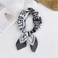 Classic black and white long silk scarf with 'THE BEST FOR' print tied in a bow - Geometric Quotes Black