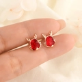 Unique red crab-shaped ear studs with golden antlers shown on a floral fabric background - Red Dragon Antler Design (C191)