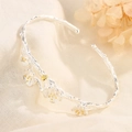 Floral branch cuff bracelet in silver and gold tones on a textured linen background - Plum Blossom Branch Style (D3)