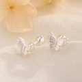 Silver butterfly screw-back earrings on minimalist textured fabric with floral accents - Butterfly Style (C266)