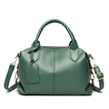 Detail of dark green Boston bag in pebbled faux leather with handles and shoulder strap - Green