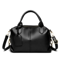 Detail of black litchi texture PU leather handbag with gold hardware and double handles - Black