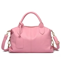 Detailed macro view of pink PU leather Boston handbag with gold metal hardware and stitching - Pink