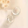 Minimalist silver hoop earrings with irregular twisted texture on beige knit background - Silver Twist Geometric Style (HL-119)
