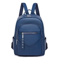 Close-up of a blue PU leather backpack with pebble grain texture and multiple zip pockets - Blue