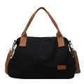 Minimalist black canvas tote bag with brown leather handles and adjustable shoulder strap - Black