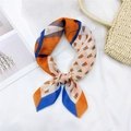 Chic cotton linen square scarf with geometric pattern in orange and blue tied on a straw bag - 24 Cotton Horse Head Orange Blue