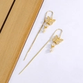 Long butterfly tassel earrings in gold with pavé cubic zirconia on minimalist background - Gold