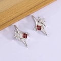 Star-shaped earrings with red zircon in silver metal on light purple background - Four-Pointed Star Red Zircon Style (XP54)