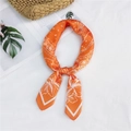 Orange paisley silk square scarf tied in a bow with floral print on white background - Orange Floral Paisley