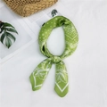 Green silk-texture square scarf with white paisley patterns in a looped knot display - Green Floral Paisley