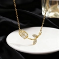 Macro detail of tulip necklace with teardrop crystal pendant on black satin background - Necklace / Clear