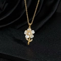 Detalle macro de collar con colgante de flor dorada, pétalos blancos y perla central - Estilo Dorado Flor de Cinco Pétalos Nácar (F)
