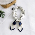 Elegant ivory silk square scarf with navy equestrian stirrup print in a knotted style - White Horsebit
