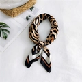 Silk leopard print square neck scarf with gold and brown tones in a knotted style - Yellow Black Border Symmetrical Leopard