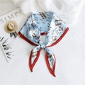 Blue diamond-shaped silk scarf with music notes and red border tied as a bow - Musical Note Red Edge