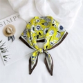 Elegant yellow silk scarf with blue and white floral print tied in a bow shape - Sunflower Yellow