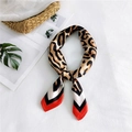 Elegant leopard print silk scarf with geometric color blocking in brown and orange - Red Border Symmetrical Leopard