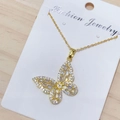 Close-up of golden butterfly pendant necklace with sparkling cubic zirconia stones - White Butterfly Style (A)