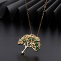 Detail of tree of life pendant with green and white zircons on polished gold plating - Round Green and White Zirconia Style (B)