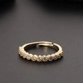 Detail of a golden adjustable ring with clear pavé zircon stones on a dark textured surface - Adjustable Open / Clear Zirconia Row Style (B)
