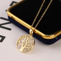 Detailed close-up of tree of life pendant with colorful stones on blue velvet box - Round Light Color Diamond Style (E)