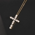 Cross pendant necklace with colorful zircon stones on gold chain over black leather - White Gemstone