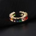 Adjustable gold ring with colorful oval-cut rainbow zircon stones on black background - Gold Oval Rainbow Zircon Cuff Ring