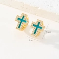 Détail macro de boucles d'oreilles croix plaquées or 18K avec émail bleu et CZ - Style Croix en Émail Bleu Paon (N)