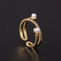 Detail view of gold-plated open ring featuring two pearls and shimmering cubic zirconia pavé - Double Track Intertwined Pearl Style (F)