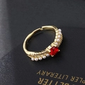 Macro detail of gold-plated ring featuring red gemstone and side pearl accents - Square Ruby Pearl Style (Style 3)