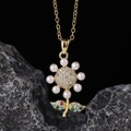 Detailed close-up of a gold flower pendant with white pearls and multicolored gemstones - Pearl Petal Colorful Gemstone Style (D)