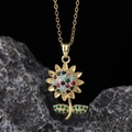 Close-up of golden sunflower pendant with multi-colored gemstones on a textured rock base - Colorful Sunflower Style (E)