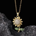 Detailed close-up of a sunflower pendant with green gemstones and white zircons - White Sunflower Green Leaf Style (G)