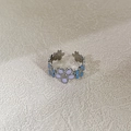 Anello regolabile in acciaio argento con petali di fiori smaltati in azzurro e viola - Argento