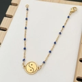 Golden stainless steel bracelet with blue beads and Tai Chi Yin Yang pendant on wood base - Blue