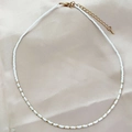 Handmade necklace with white glass seed beads and golden metallic accents on satin fabric - White